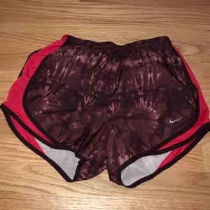 NIKE maroon running shorts with red sides